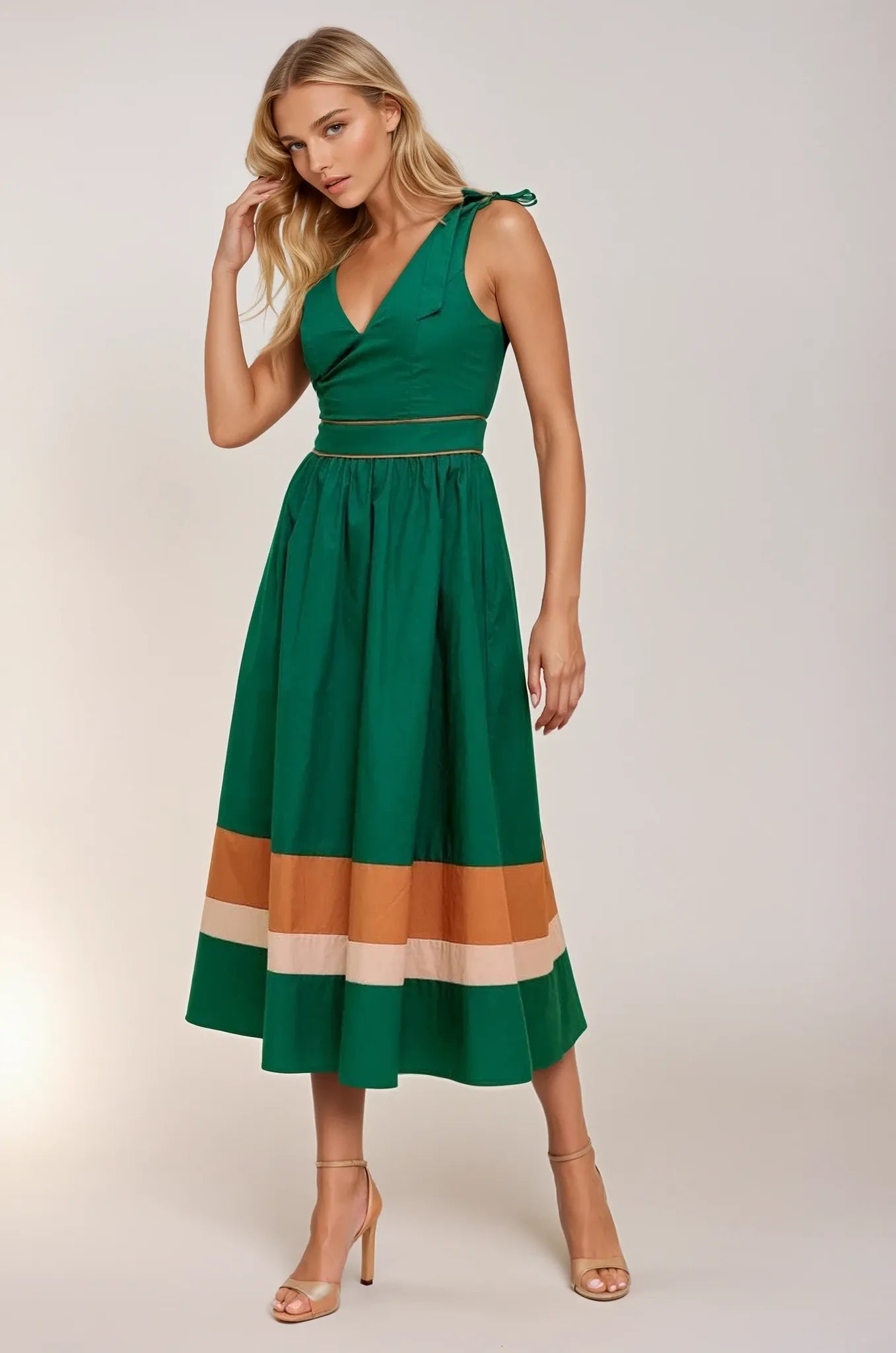 Woman wearing a green dress with color-blocked skirt on a white background. Women's dresses, midi dress, midi dresses, fall dress, fall dresses, fall styles, autumn dress, cotton dress