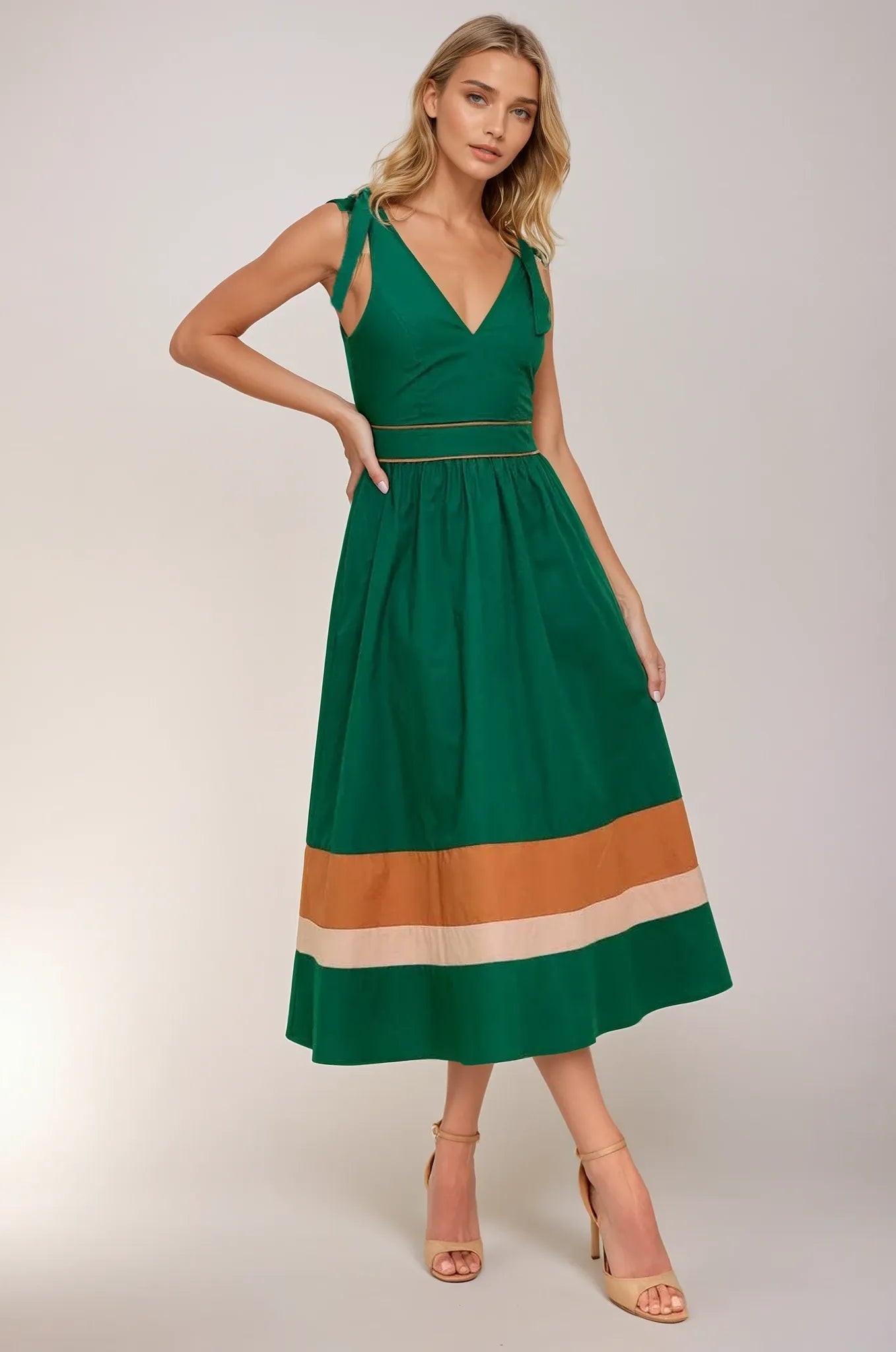 Woman wearing a green dress with a striped pattern on a plain background. Women's dress, women's dresses, fall dress, fall styles, autumn dress, cotton dress