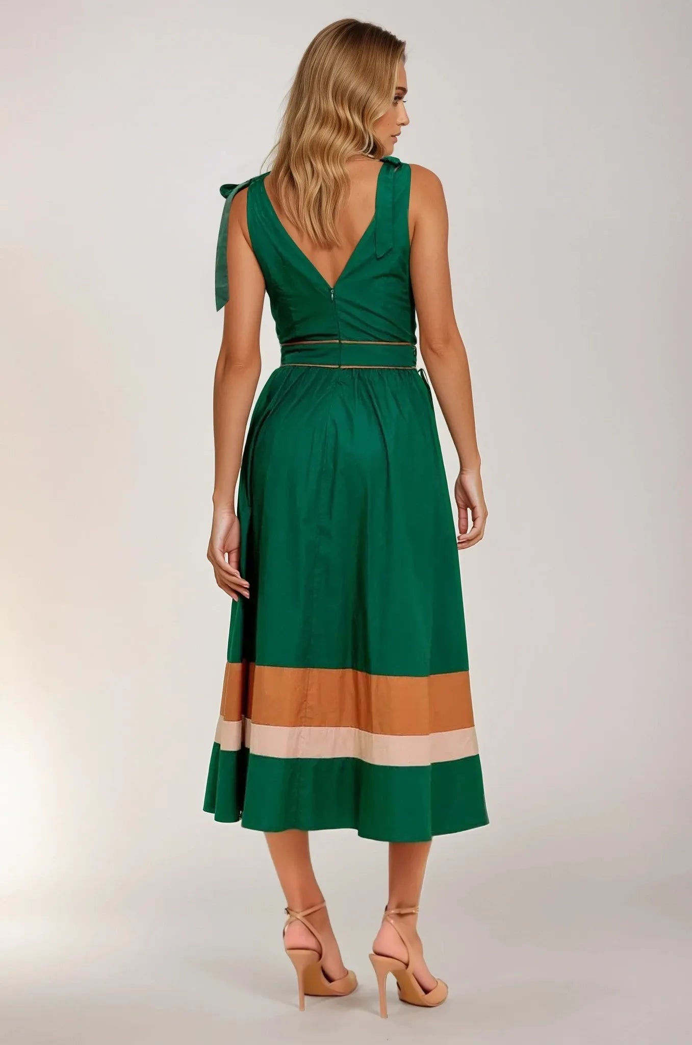 Woman wearing a green dress with a color-blocked skirt on a plain background. Women's dress, women's dresses, fall dress, fall styles, autumn dress, cotton dress