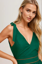 Woman wearing a green dress with a plain background. Women's dress, women's dresses, fall dress, fall styles, autumn dress, cotton dress