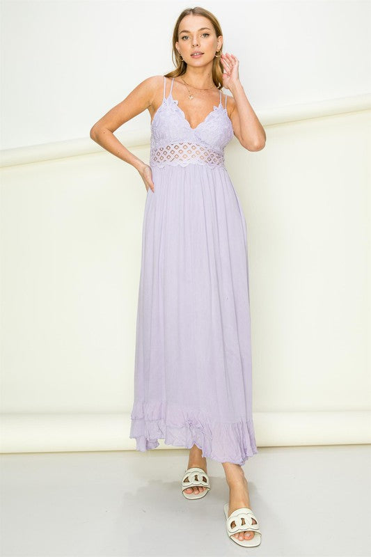 Woman wearing a light purple dress with a white background. Women's dress, maxi dress