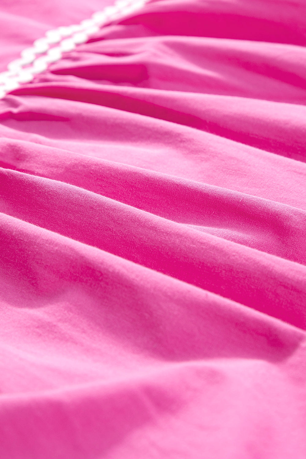 Close-up of pink fabric with a textured surface. Women's dress, 100% cotton, cotton dress, summer dress, mini dress.