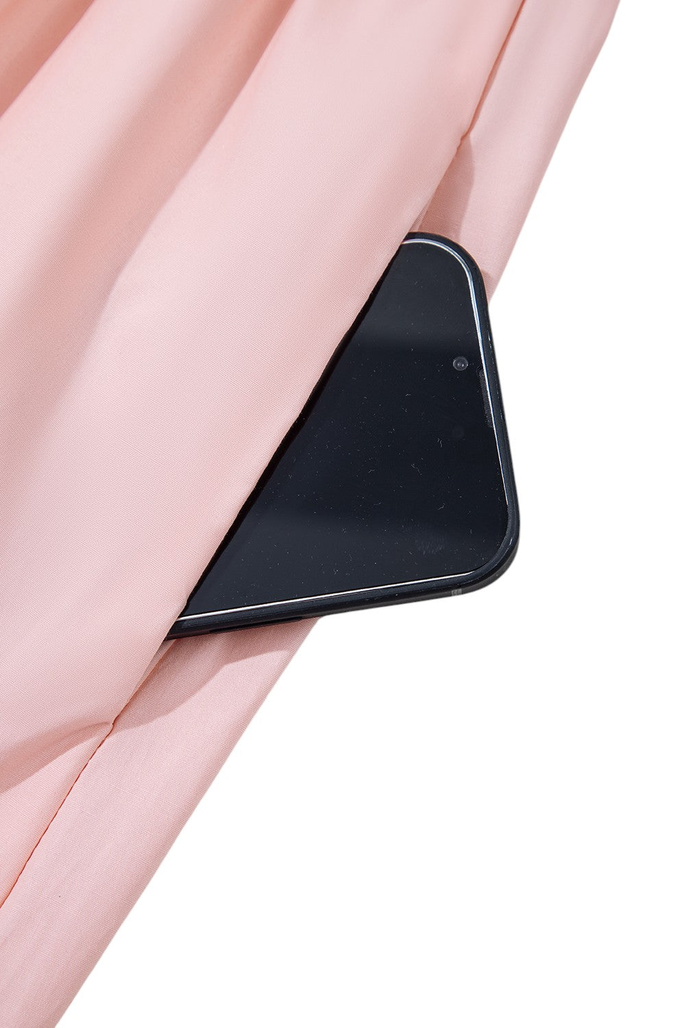 Black smartphone held between pink fabric on a white background. Women's dress, maxi dress, cotton dress, summer dress, pink dress, pink maxi dress, 100% cotton dress, dress with pockets