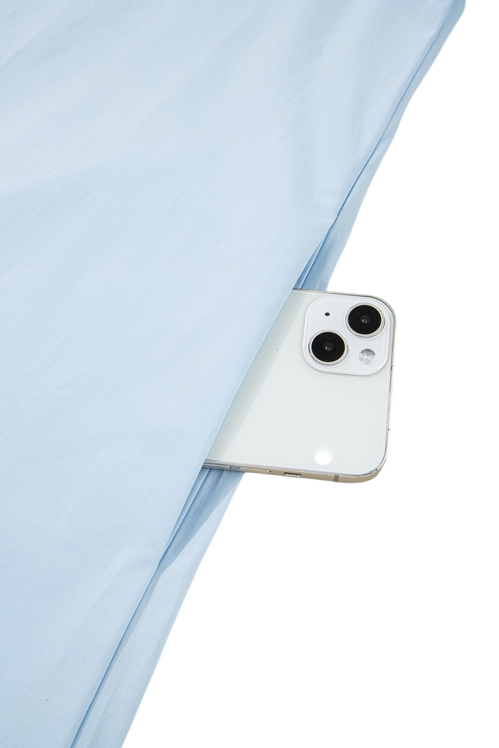 White phone case with a camera cutout on a light blue fabric background. Women's dresses, cotton dresses, mini dress