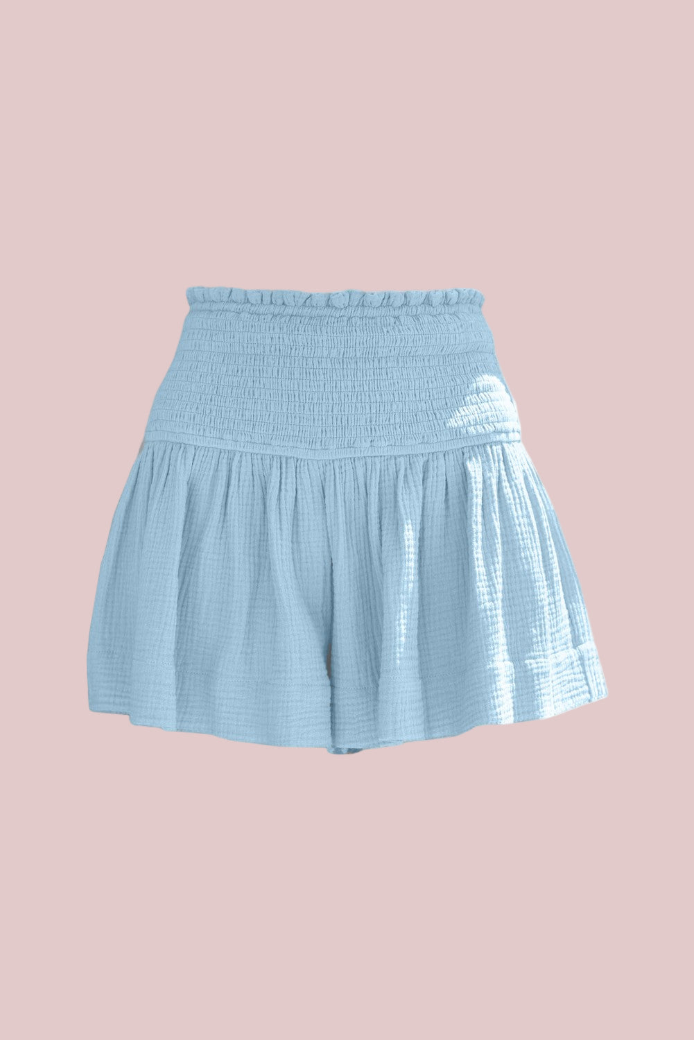 100% Cotton Pastel Blue Smocked Shorts on a pink background
