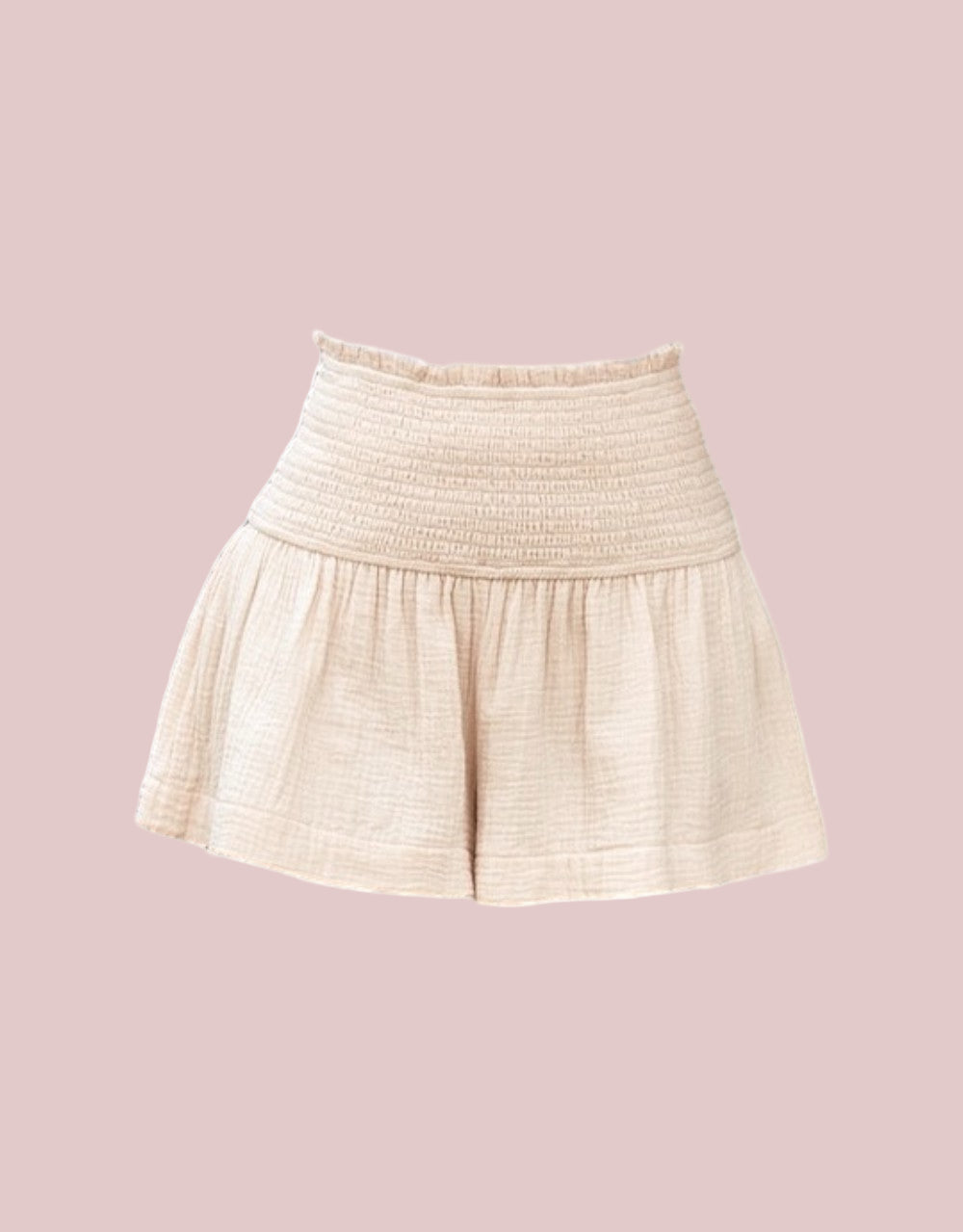 100% Cotton Light Apricot Smocked Shorts on a pink background