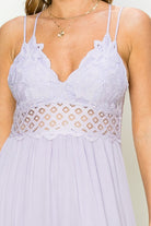 Light purple lace dress with thin straps on a neutral background. Women's dress, maxi dress