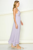 Woman wearing a light purple dress with a white background. Women's dress, maxi dress