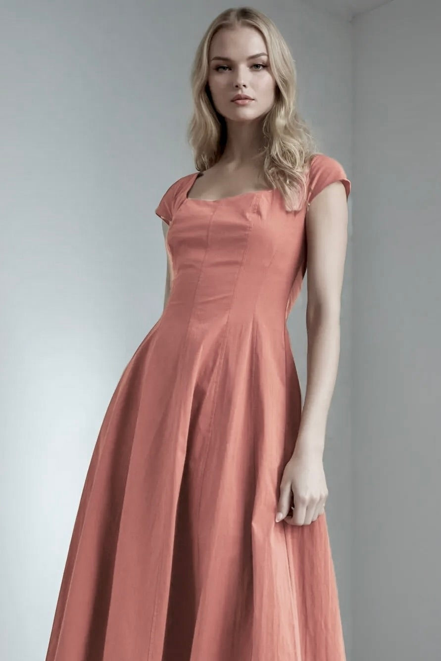 Woman wearing a long, red wood colored dress against a plain background. Women's dresses, midi dress, fall dress, fall styles, red wood color