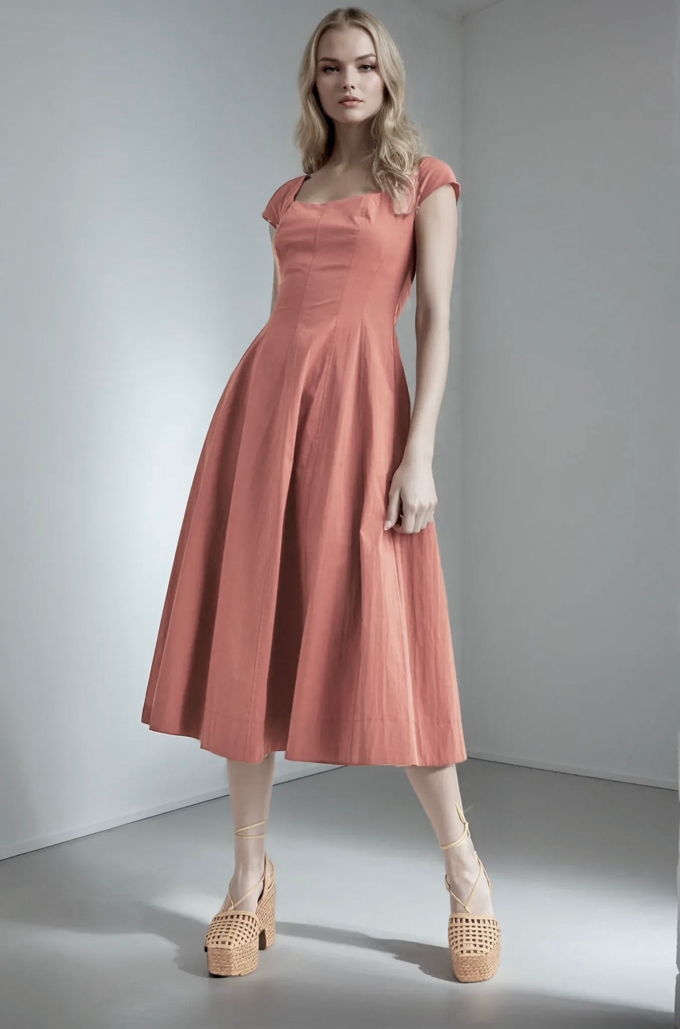 Woman wearing a red wood dress standing against a plain background. Women's dresses, redwood color, midi dress, fall dress