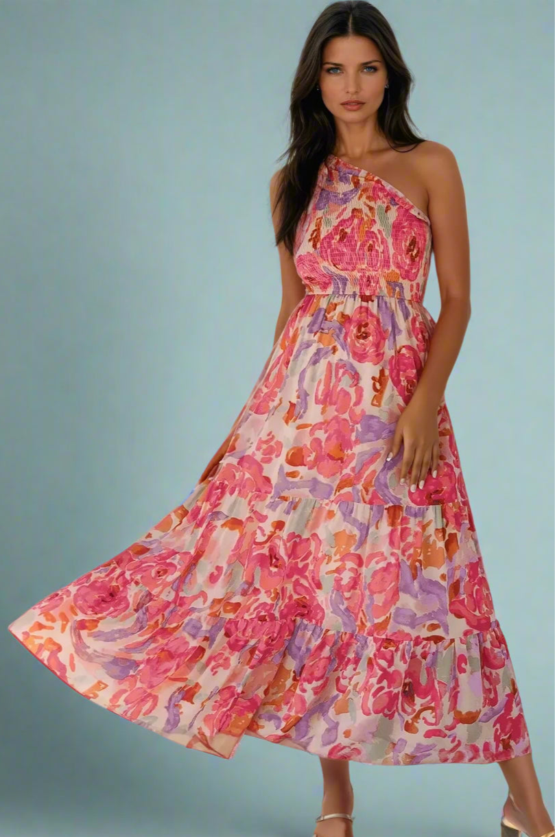 Woman wearing a One Shoulder Floral Maxi Dress against a light blue background. Women's dress, cotton dress, maxi dress.